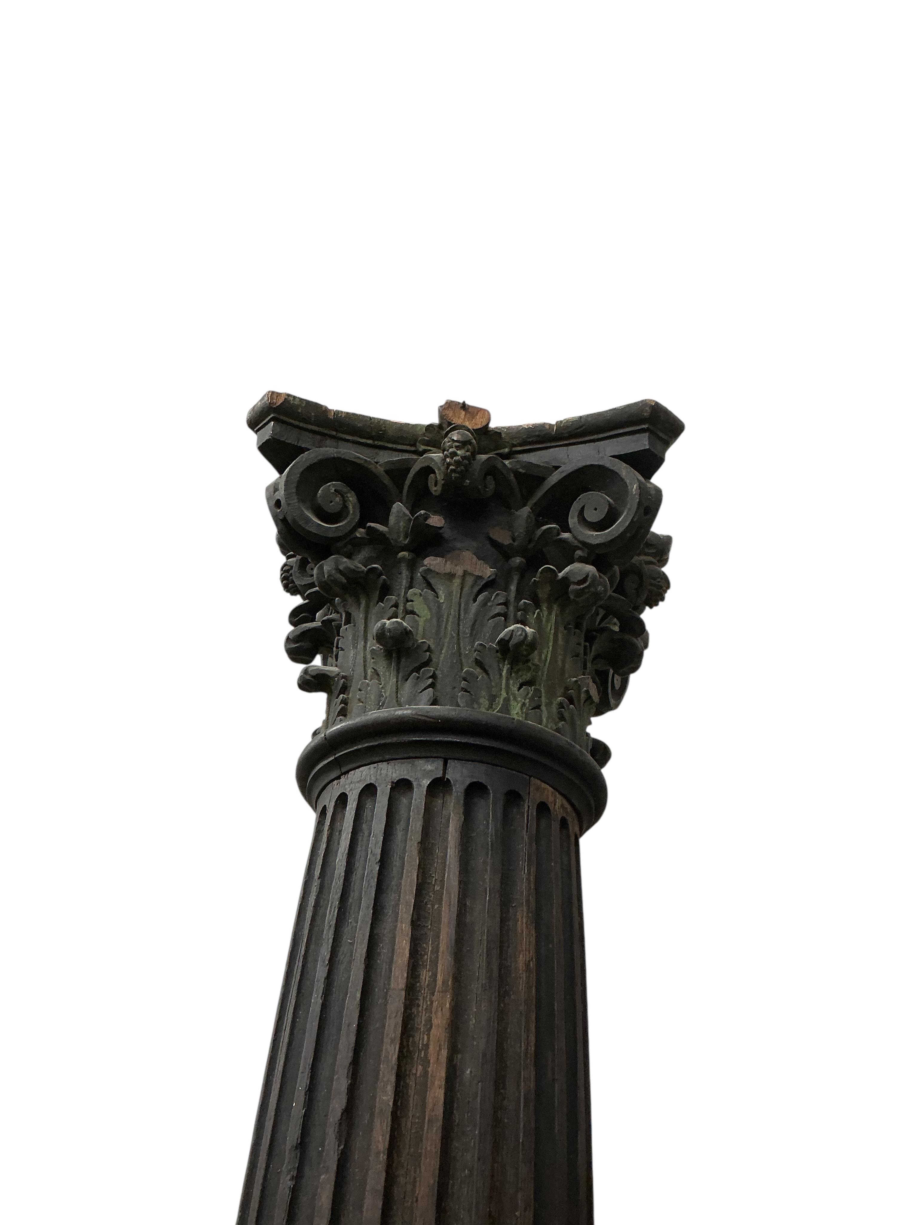 A pair of 17th century oak Corinthian columns, of large size, height 279cm, by repute from St Mary le Bow, designed by Christopher Wren